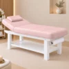 lettino per centro estetico da massaggio rosa e bianco in legno con ripiano